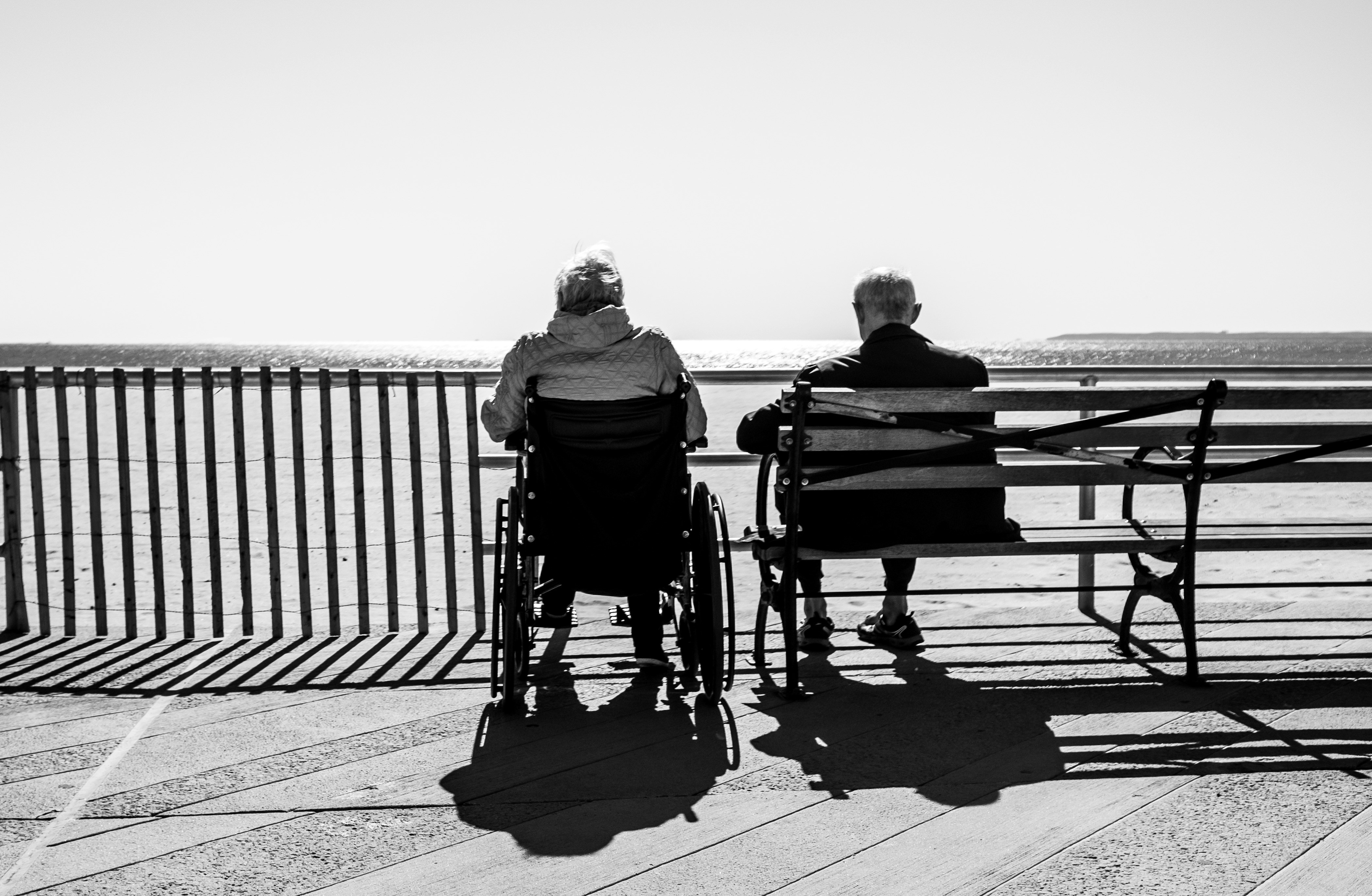 An illustrative photo of a couple sitting on the bench.