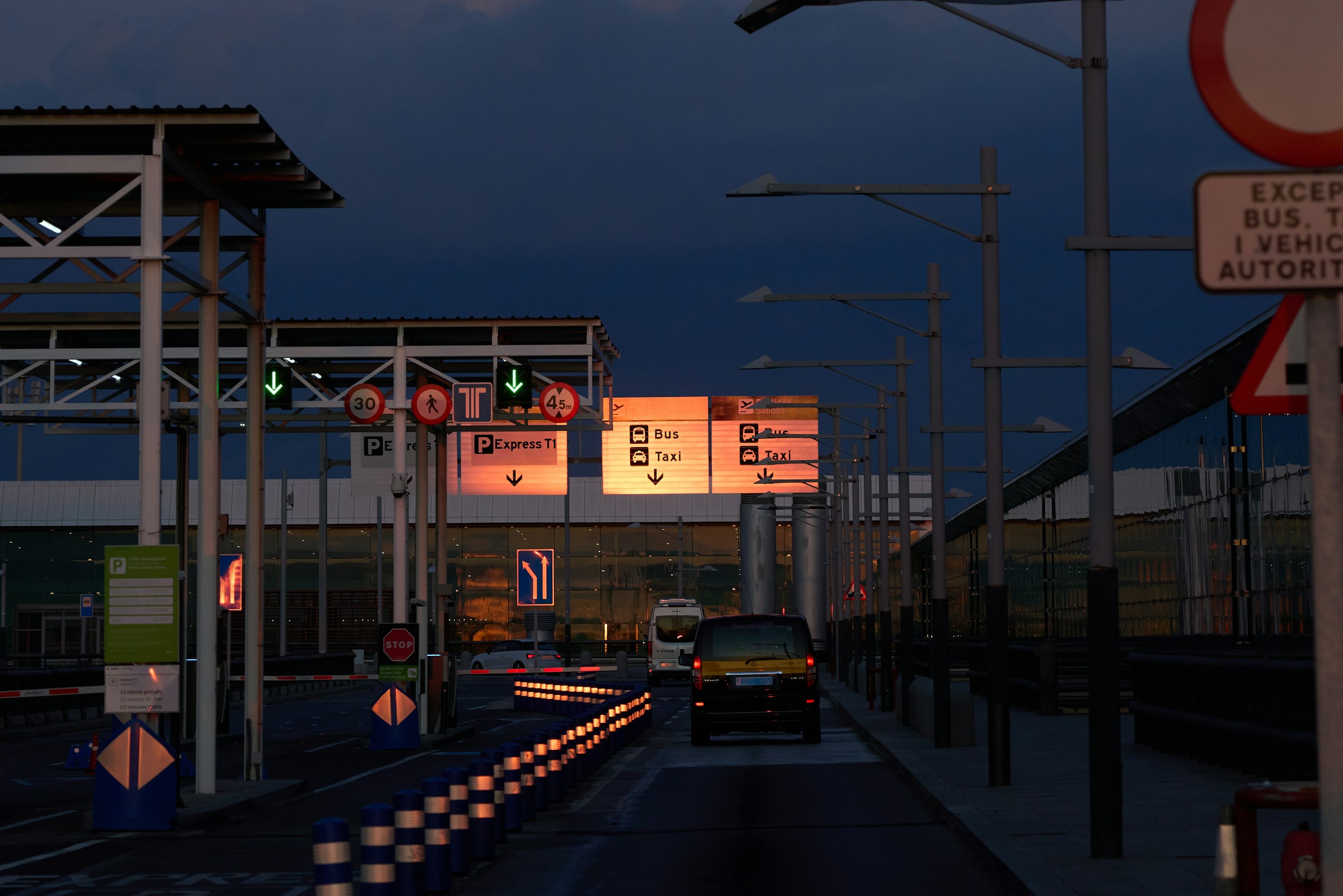 An illustrative photo of a car driving down a street.