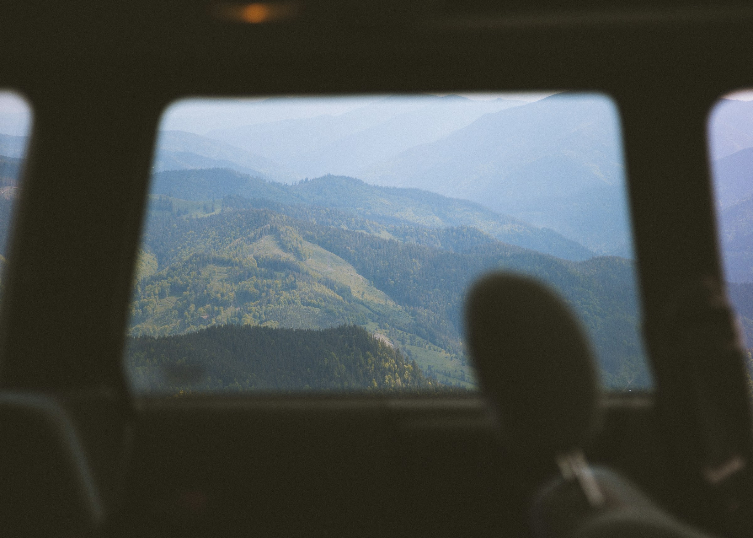 Photo by Unsplash An illustrative photo of a view of mountains from inside a vehicle.
