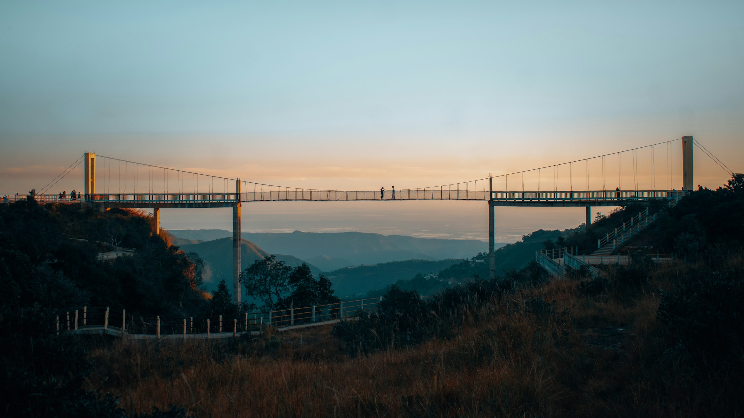 An illustrative photo of a view of a bridge from a hill.
