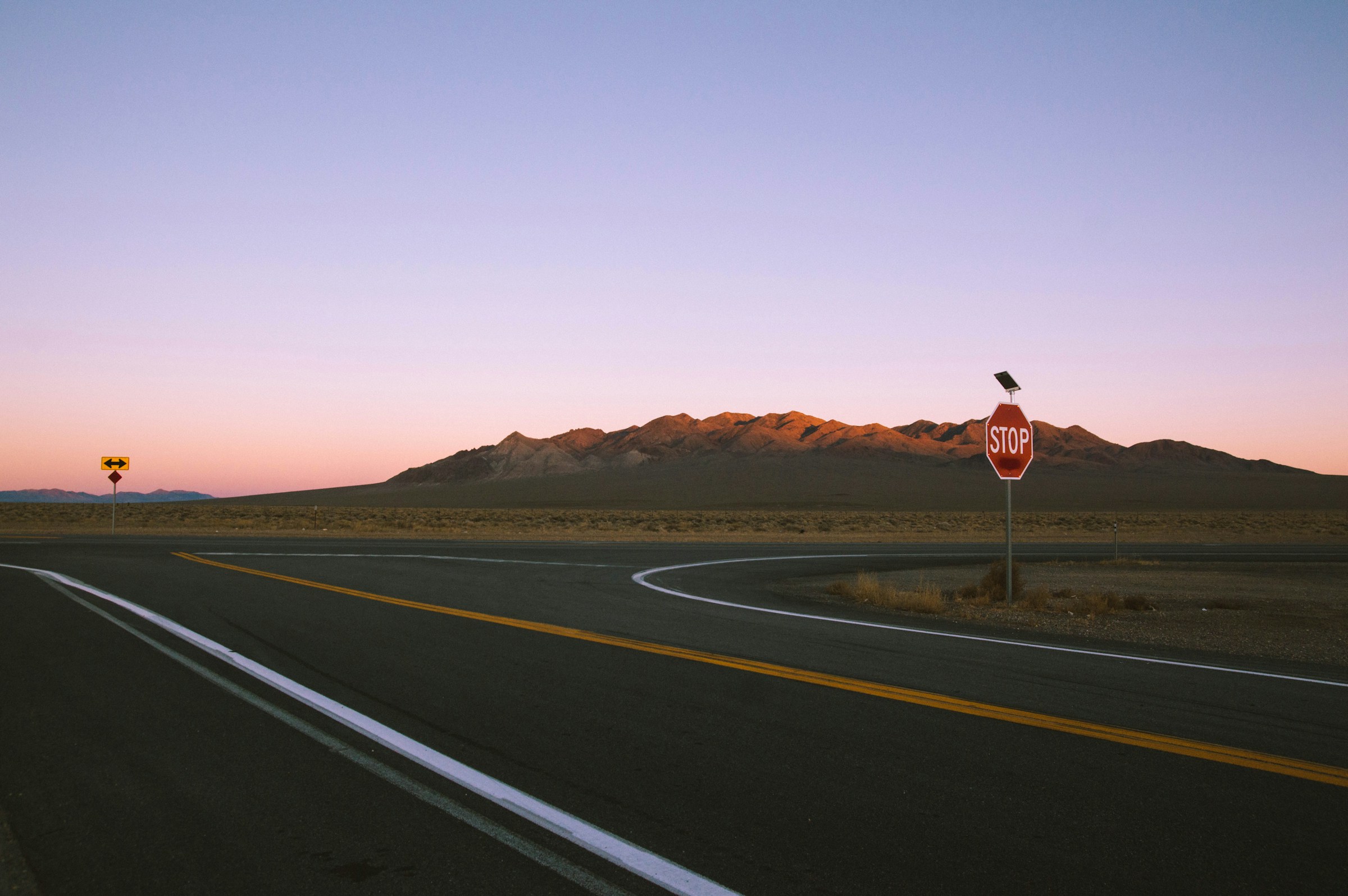 An illustrative photo of a stop sign on the side of the road.