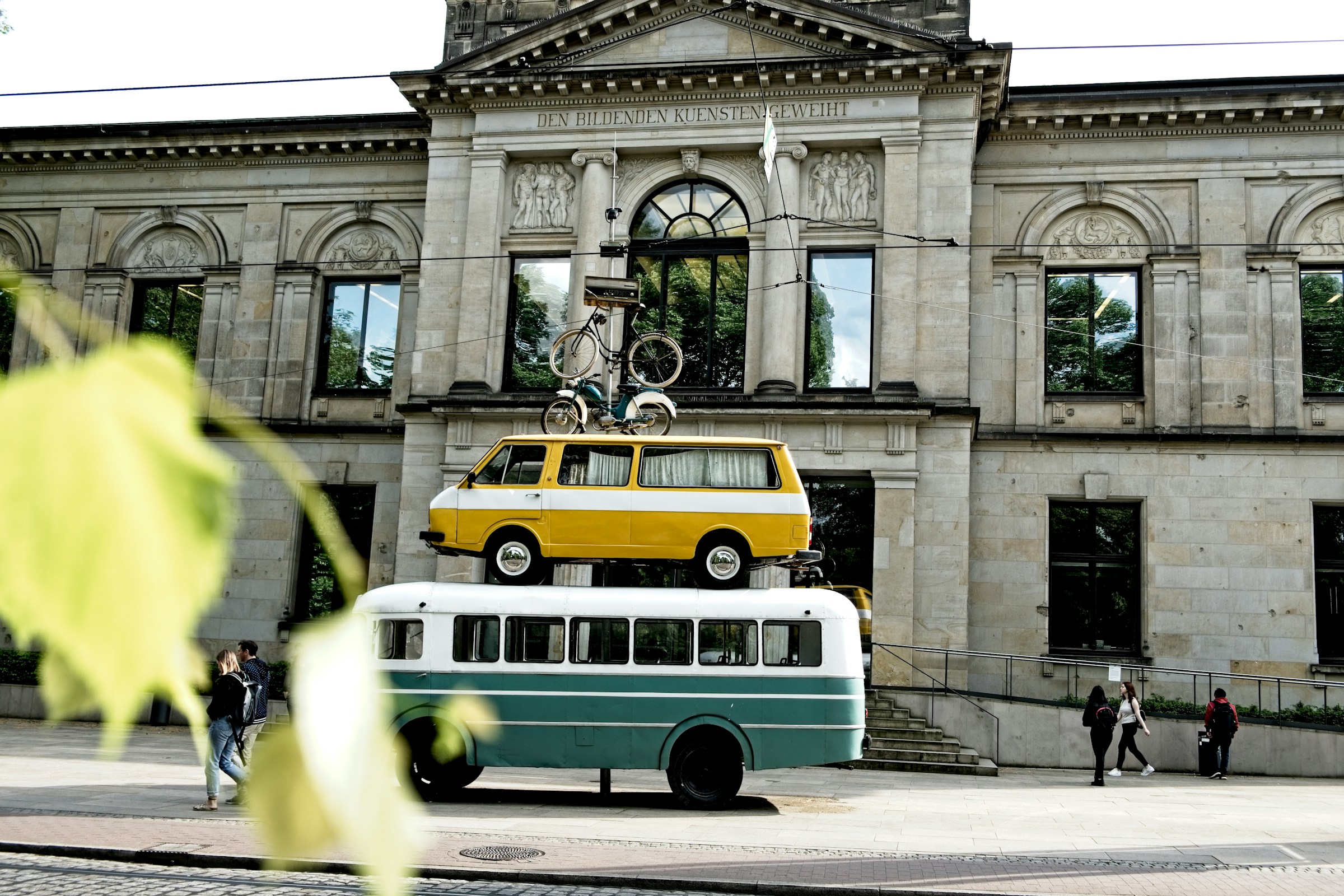 An illustrative photo of a green and white transit bus.