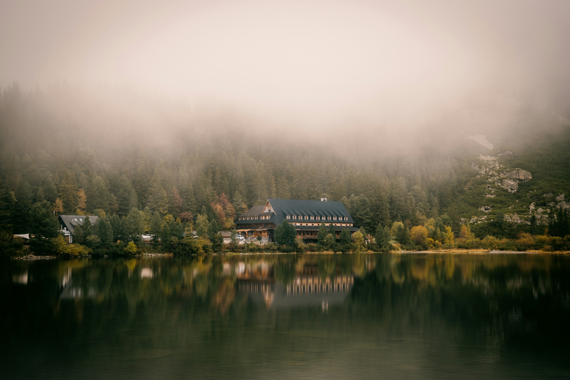 An illustrative photo of a lake with a house.