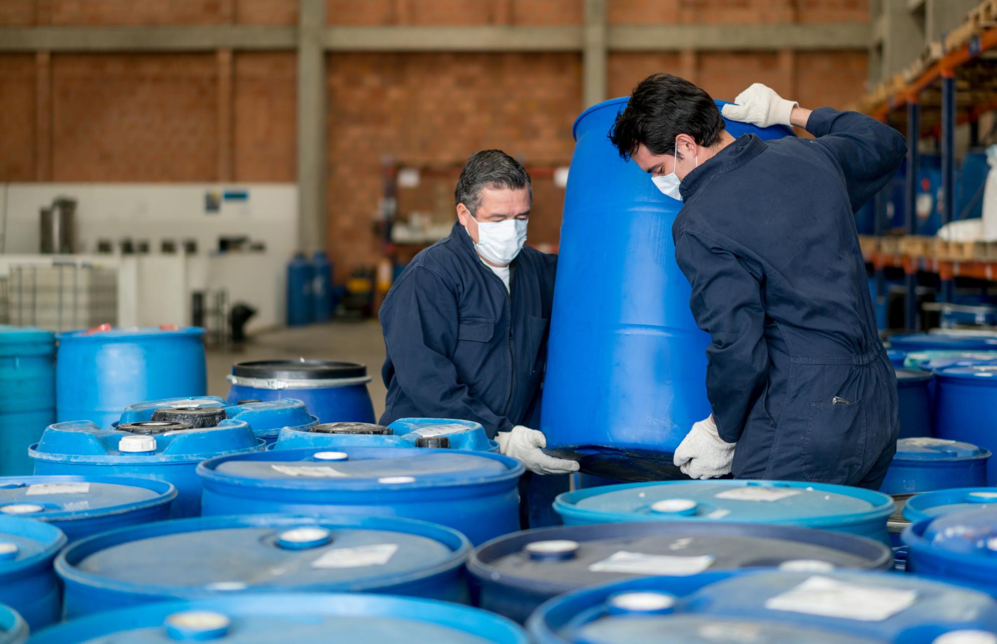 Workers holding barrels