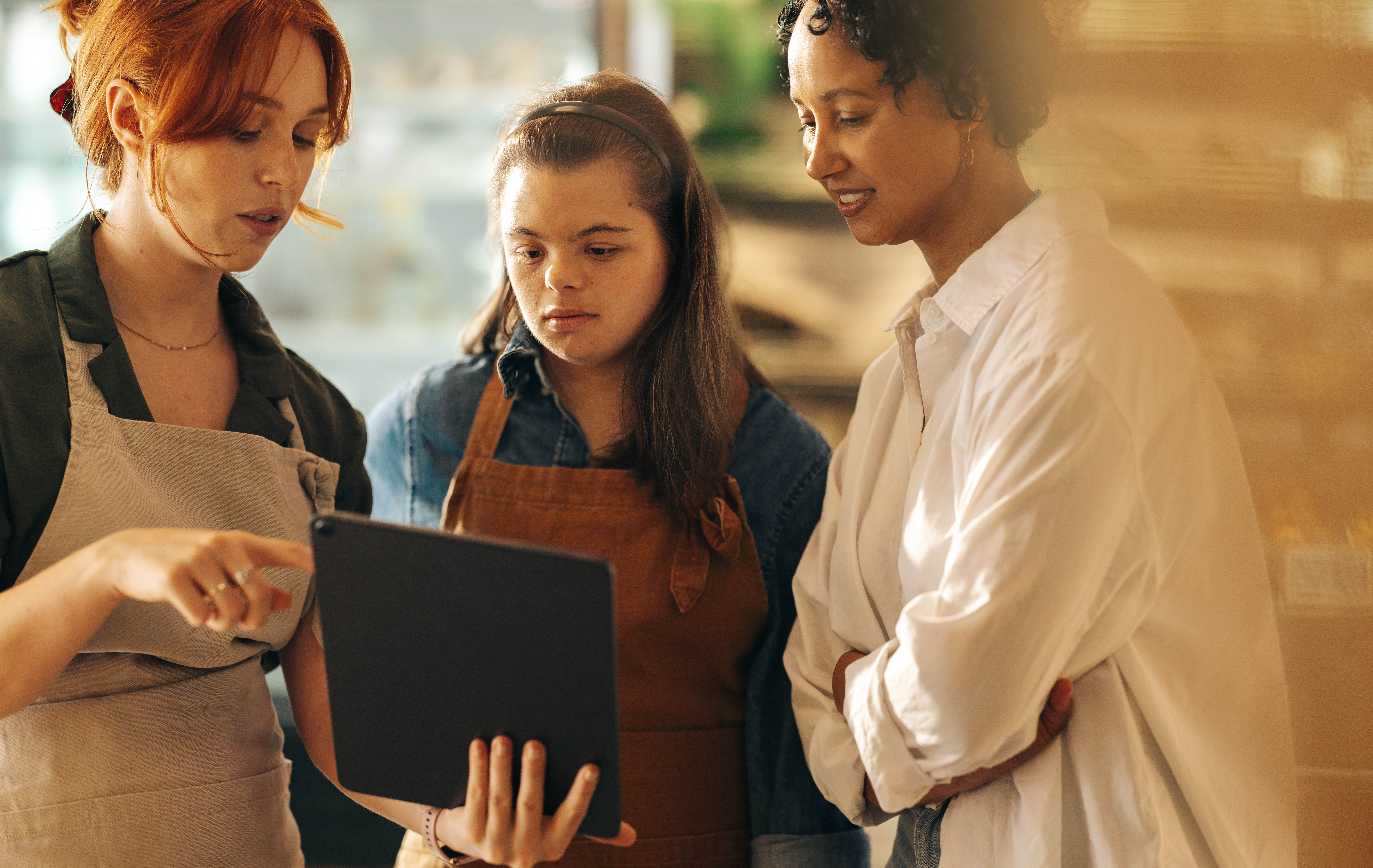 Three women looking at tablet