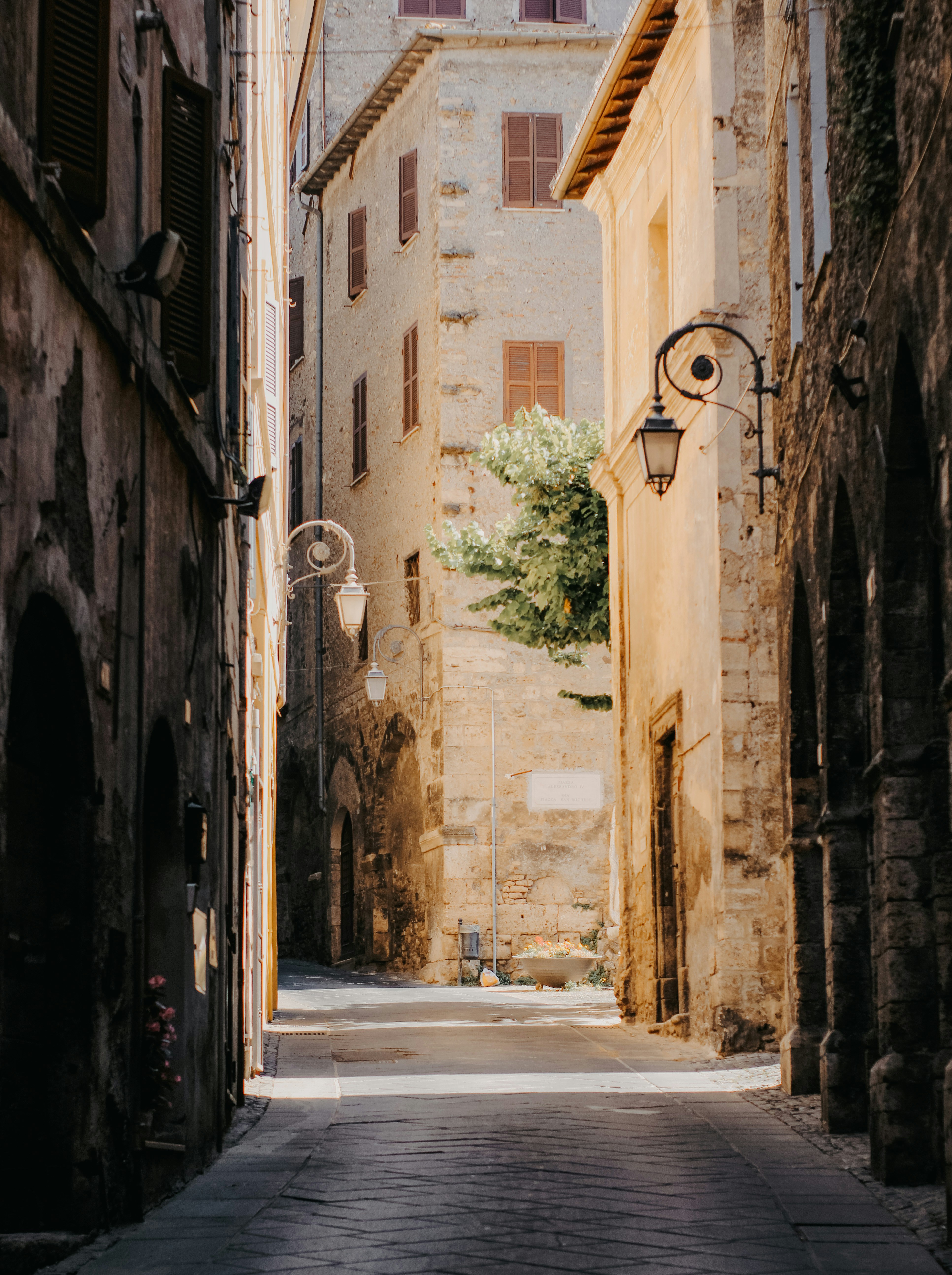 A narrow street between old, stone buildings