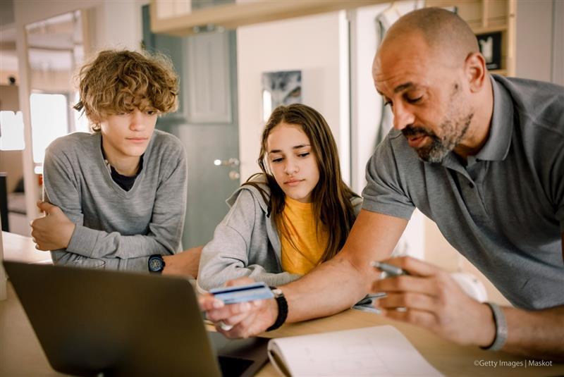 Family sitting around a laptop