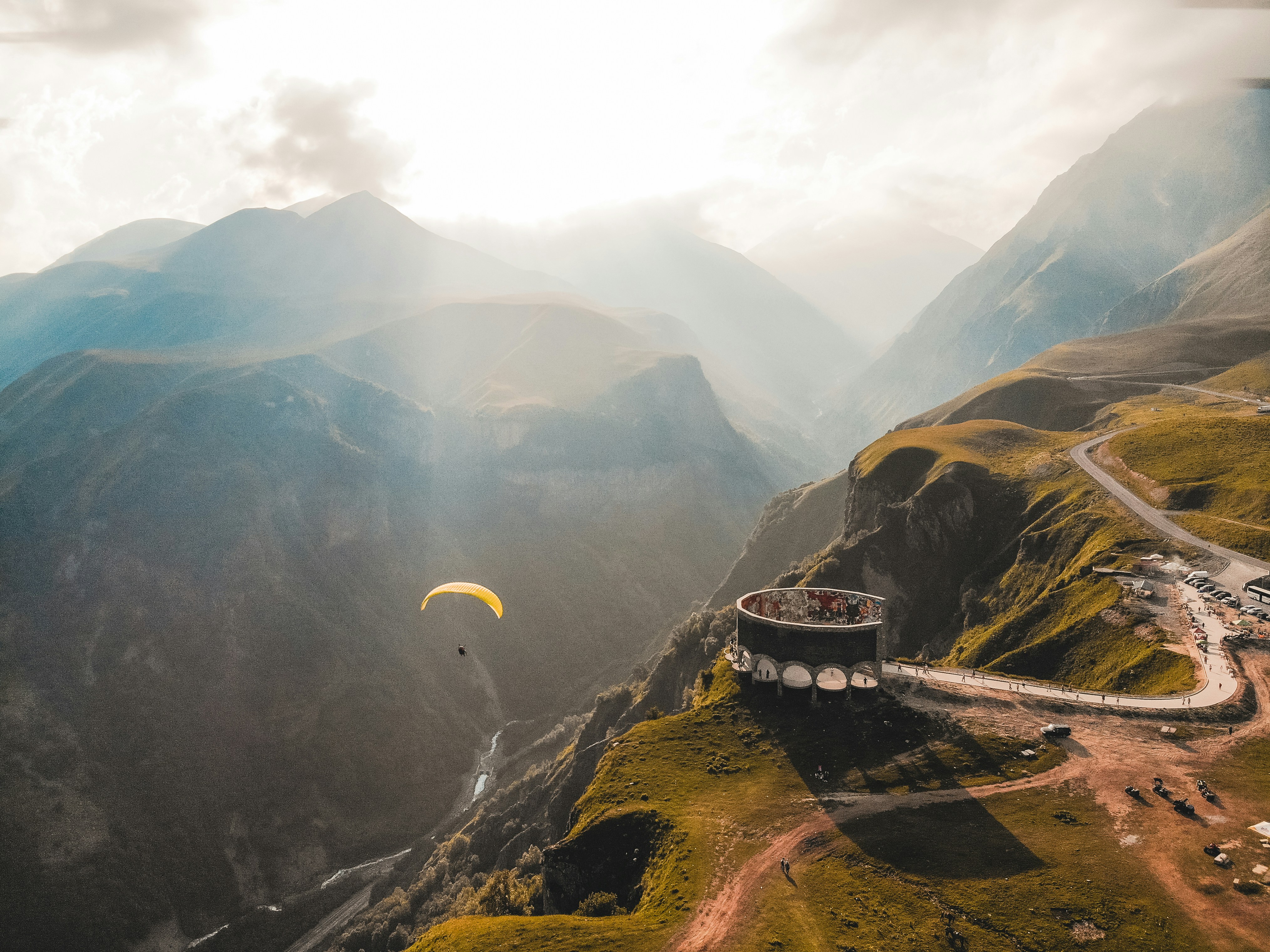 Person paragliding on the mountain cliff