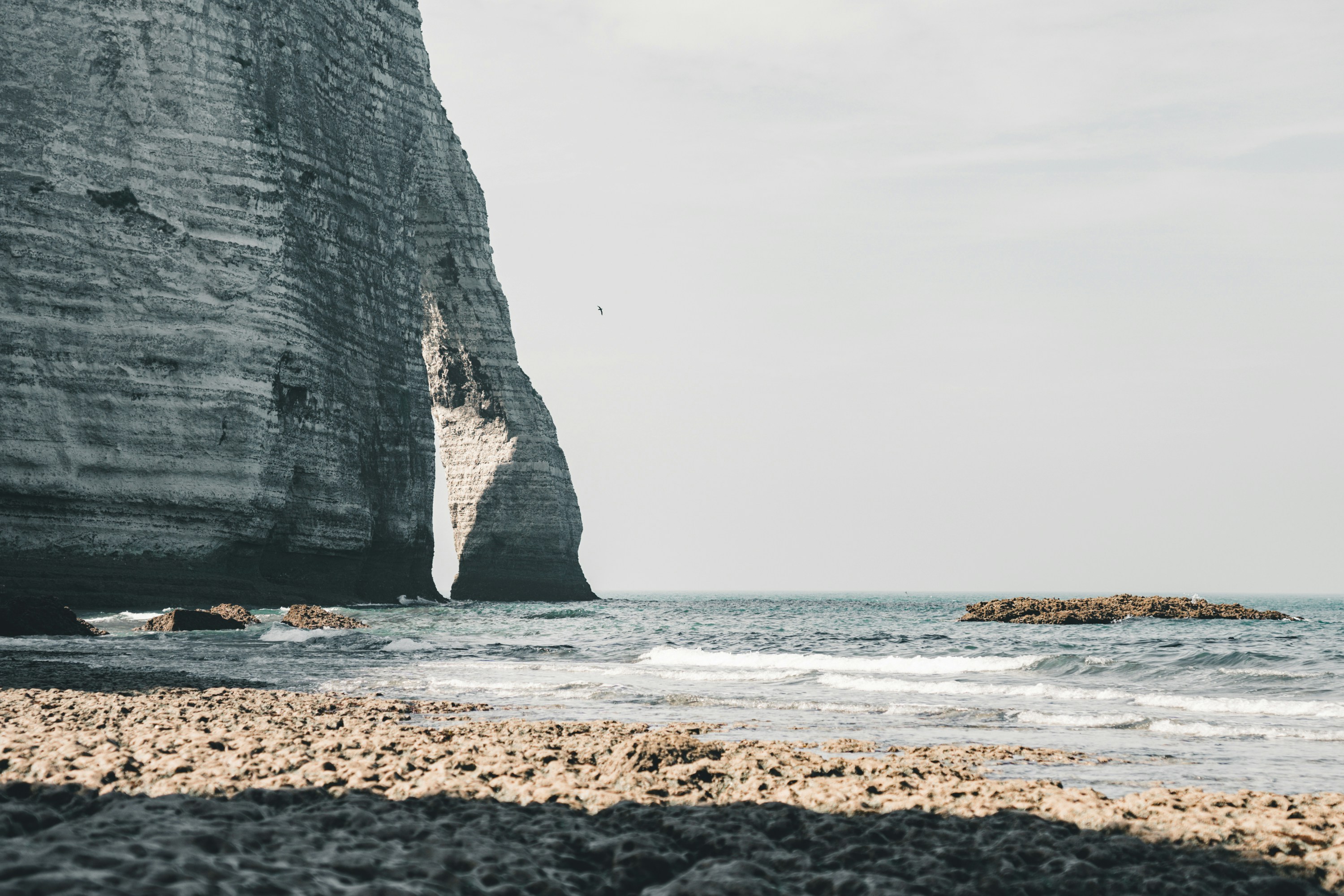 Rocky beach with a large rock formation in the background