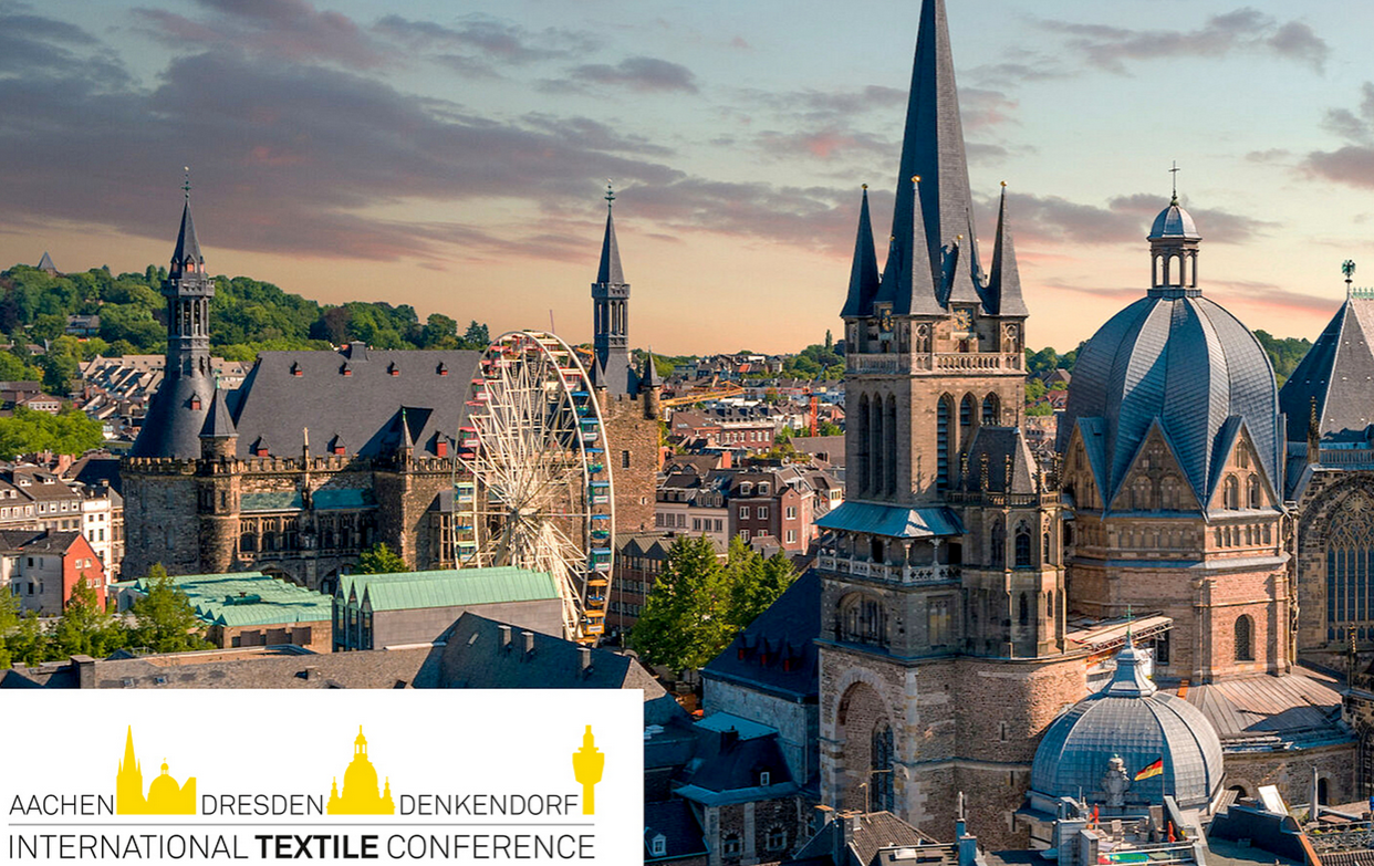 An aerial view of Aachen’s historic city centre with cathedral towers and a Ferris wheel.