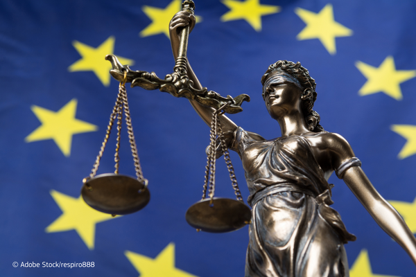 Justice statue in front of the European flag