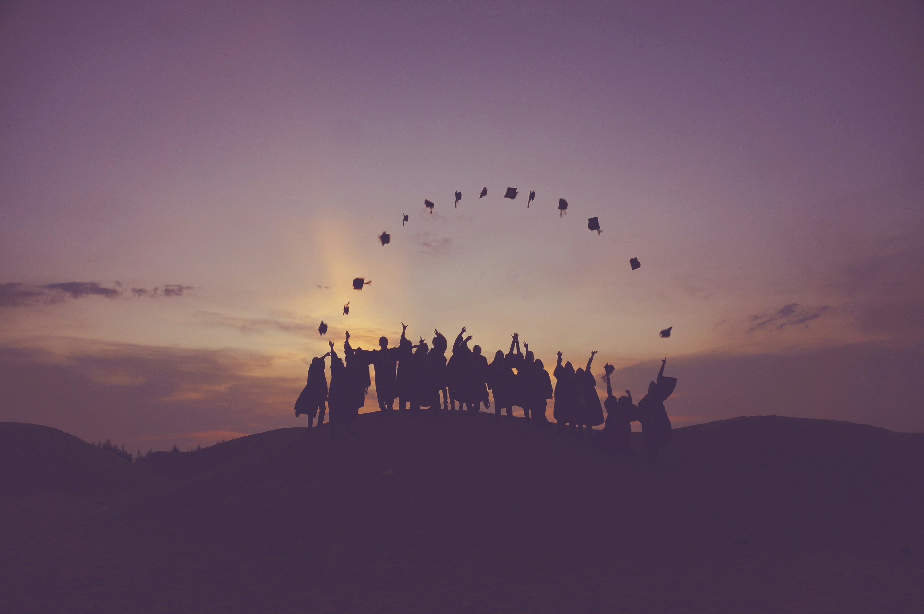 silhouettes of people against the sunset background