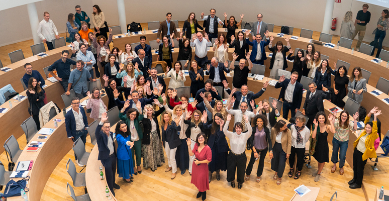 Crowd greeting the camera at the Ferrero Auditorium at SDA Bocconi