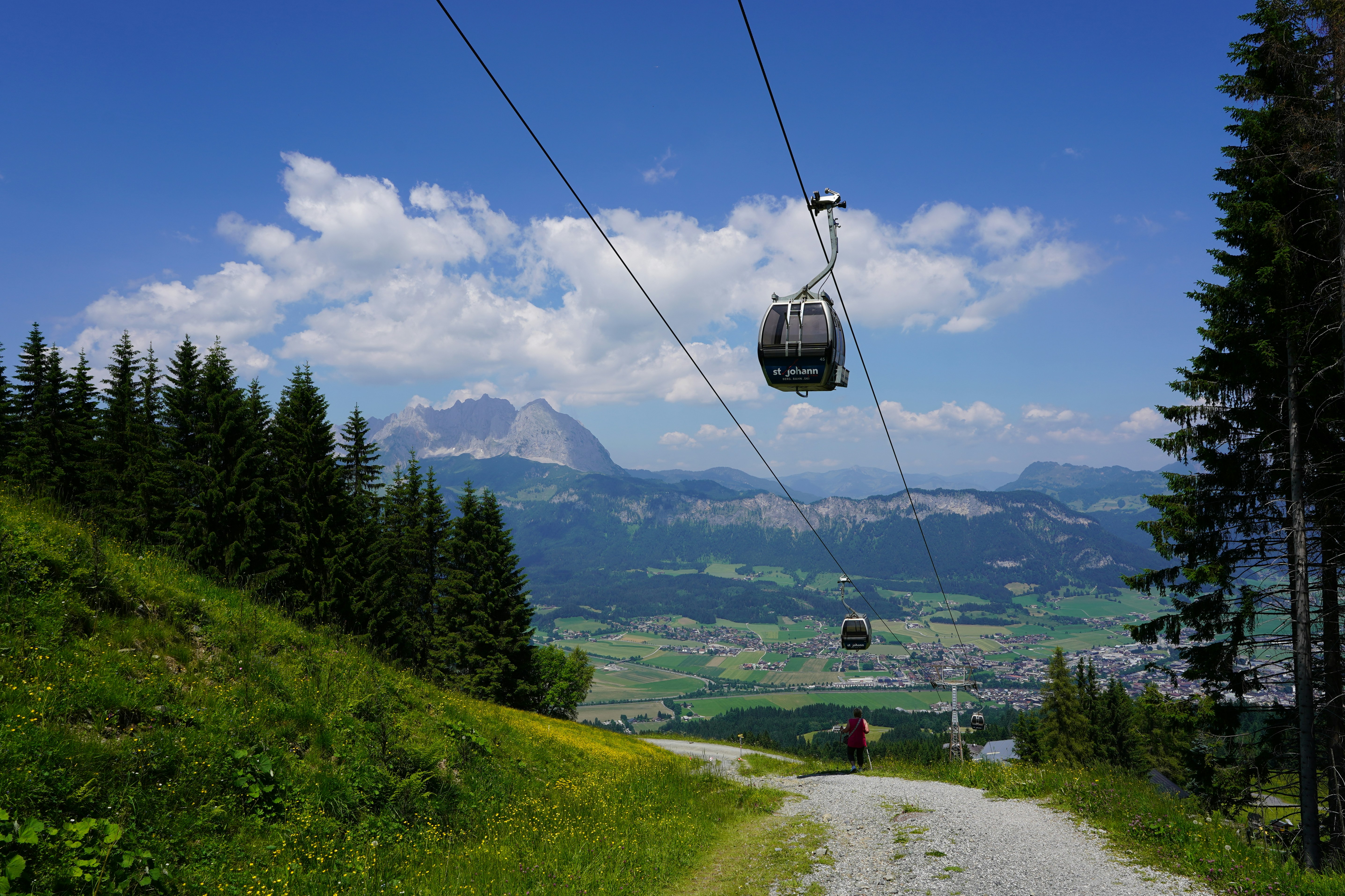 A cable car with a mountain view behind