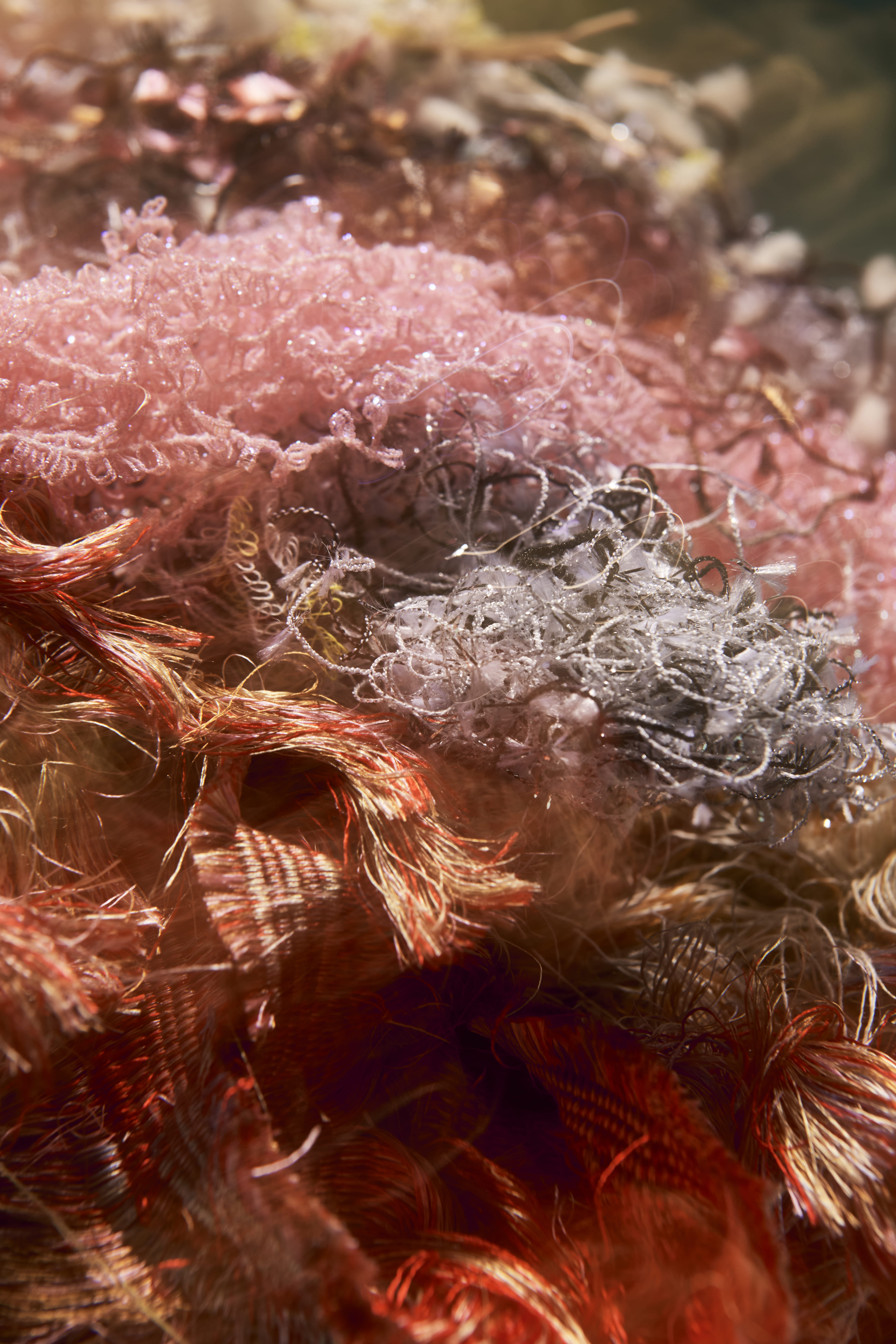 macro shot of tangled, colorful fibers and threads