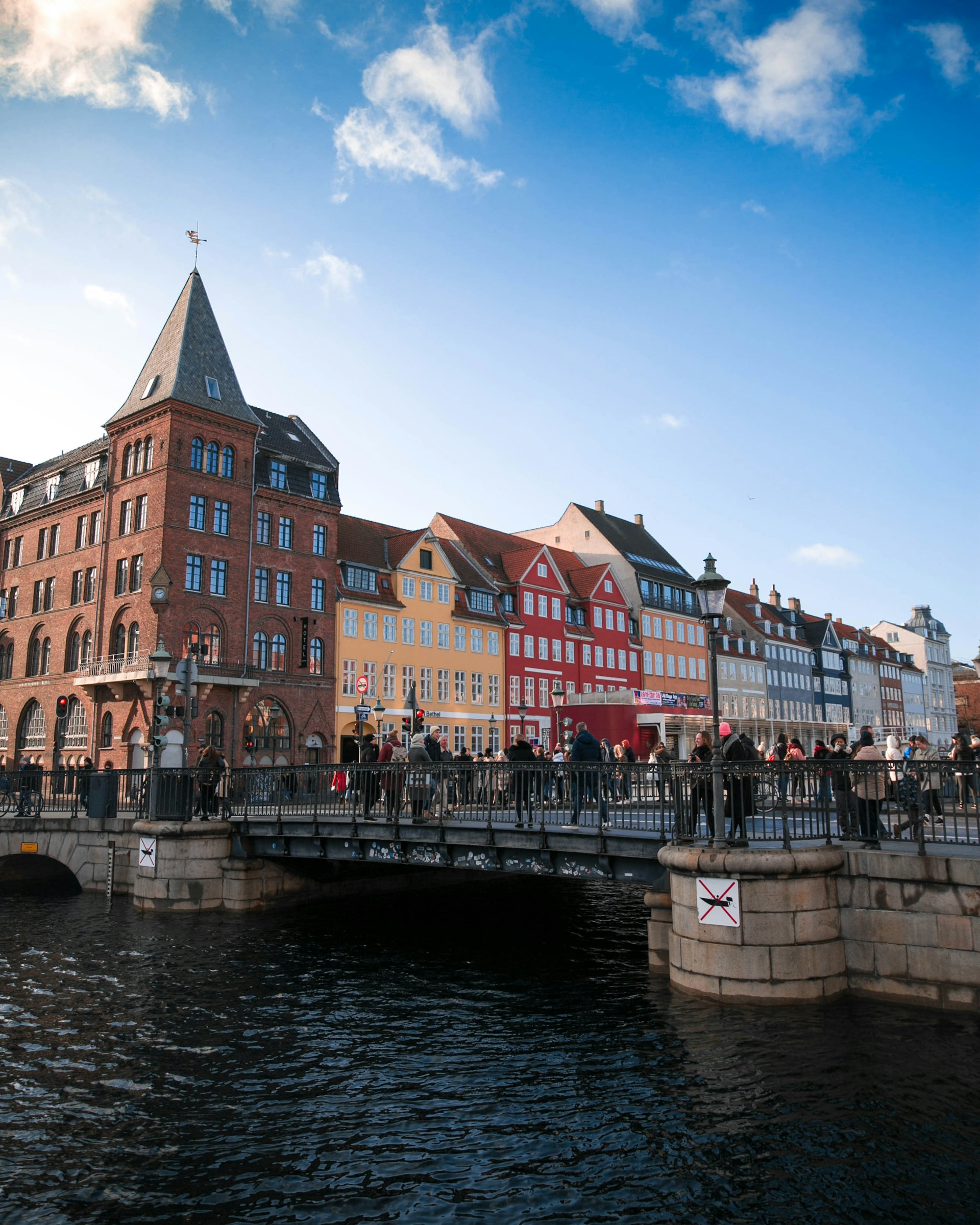 people-walking-on-bridge-near-buildings-during-daytime