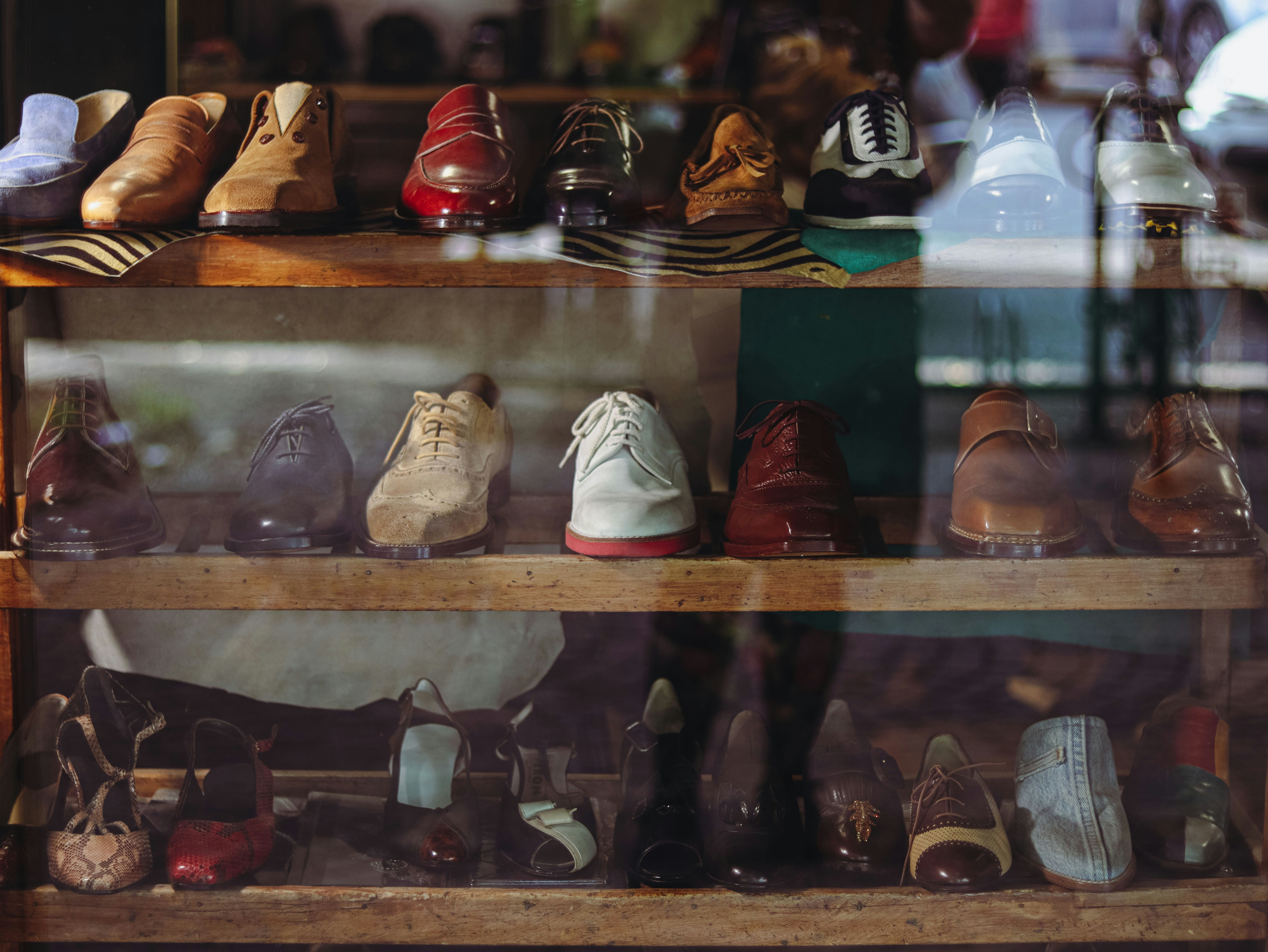 A display case filled with lots of different types of shoes. 