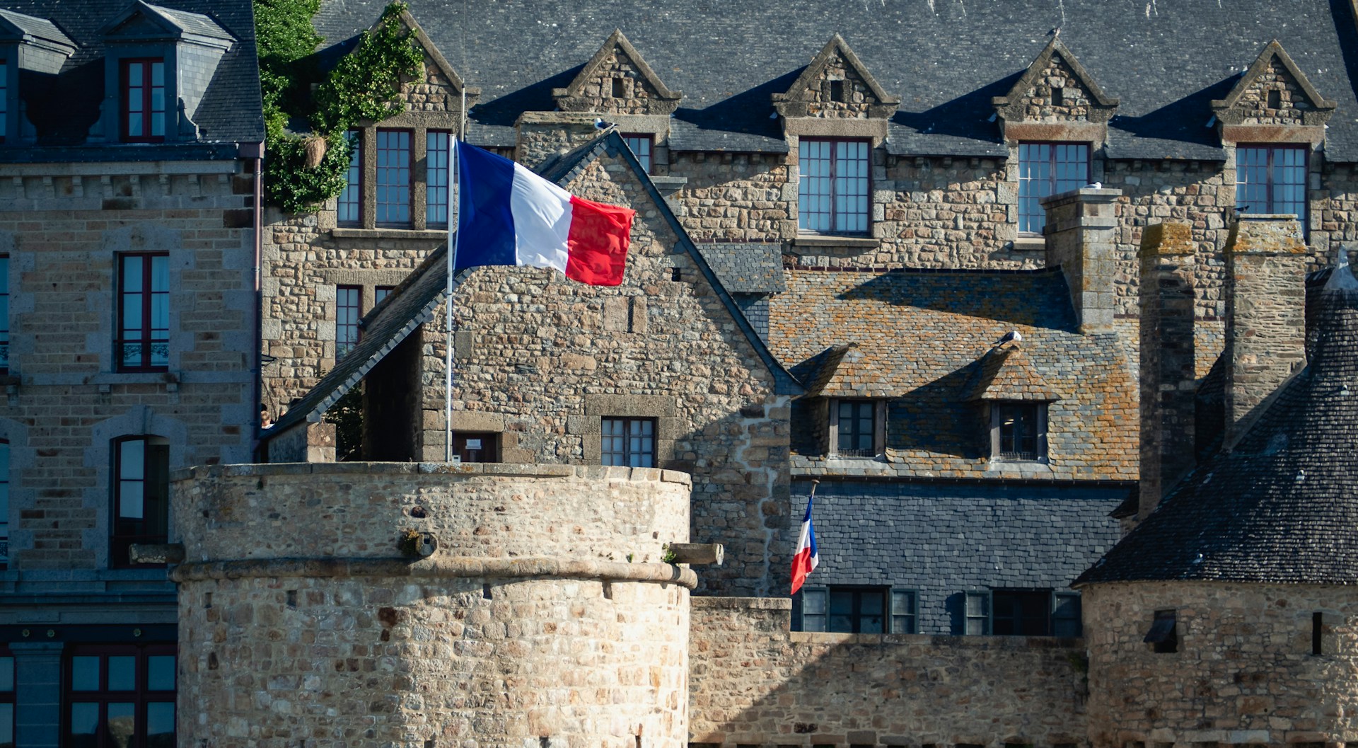 french-flag-waves-proudly-over-the-stone-buildings