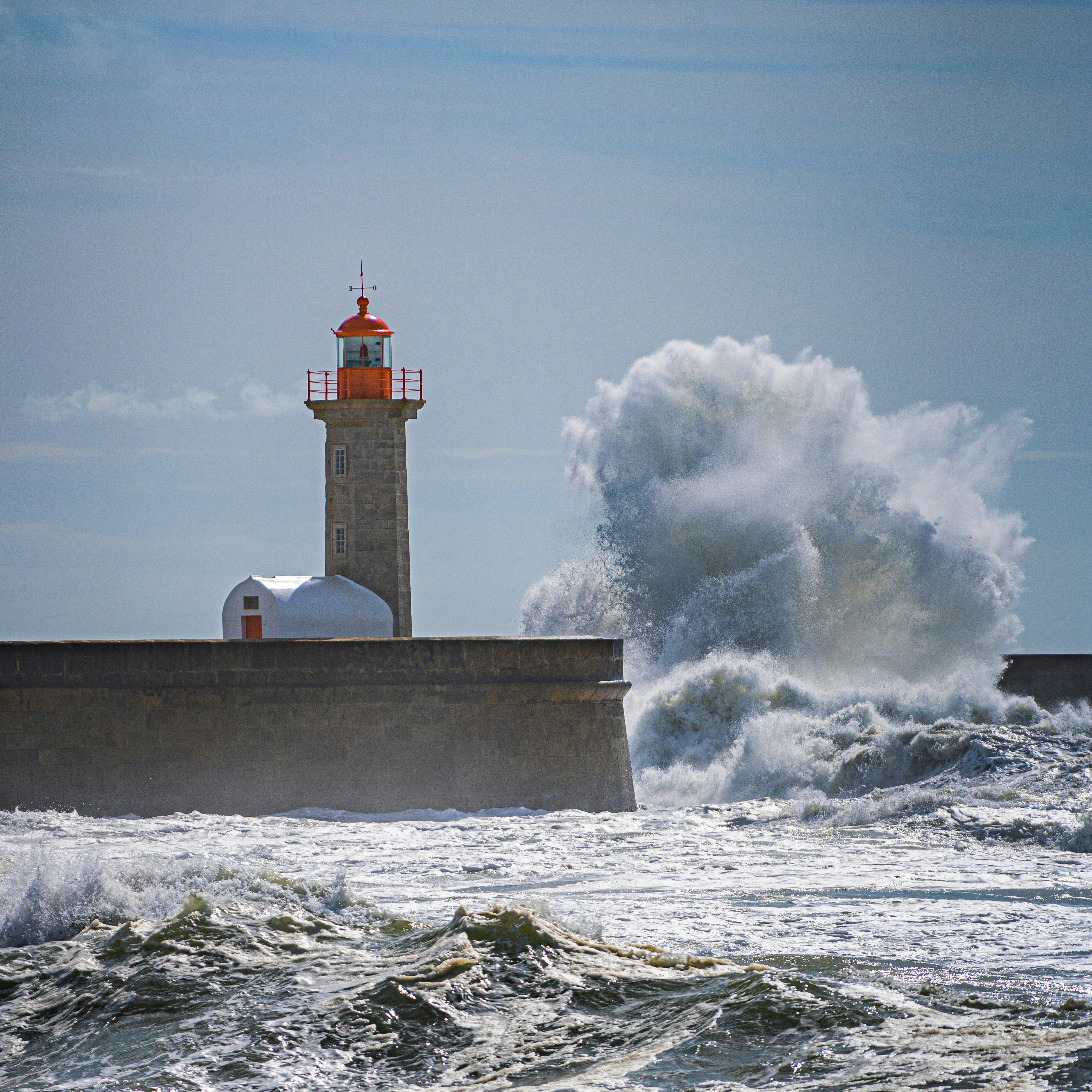 a-lighthouse-surrounded-by-waves-in-the-ocean