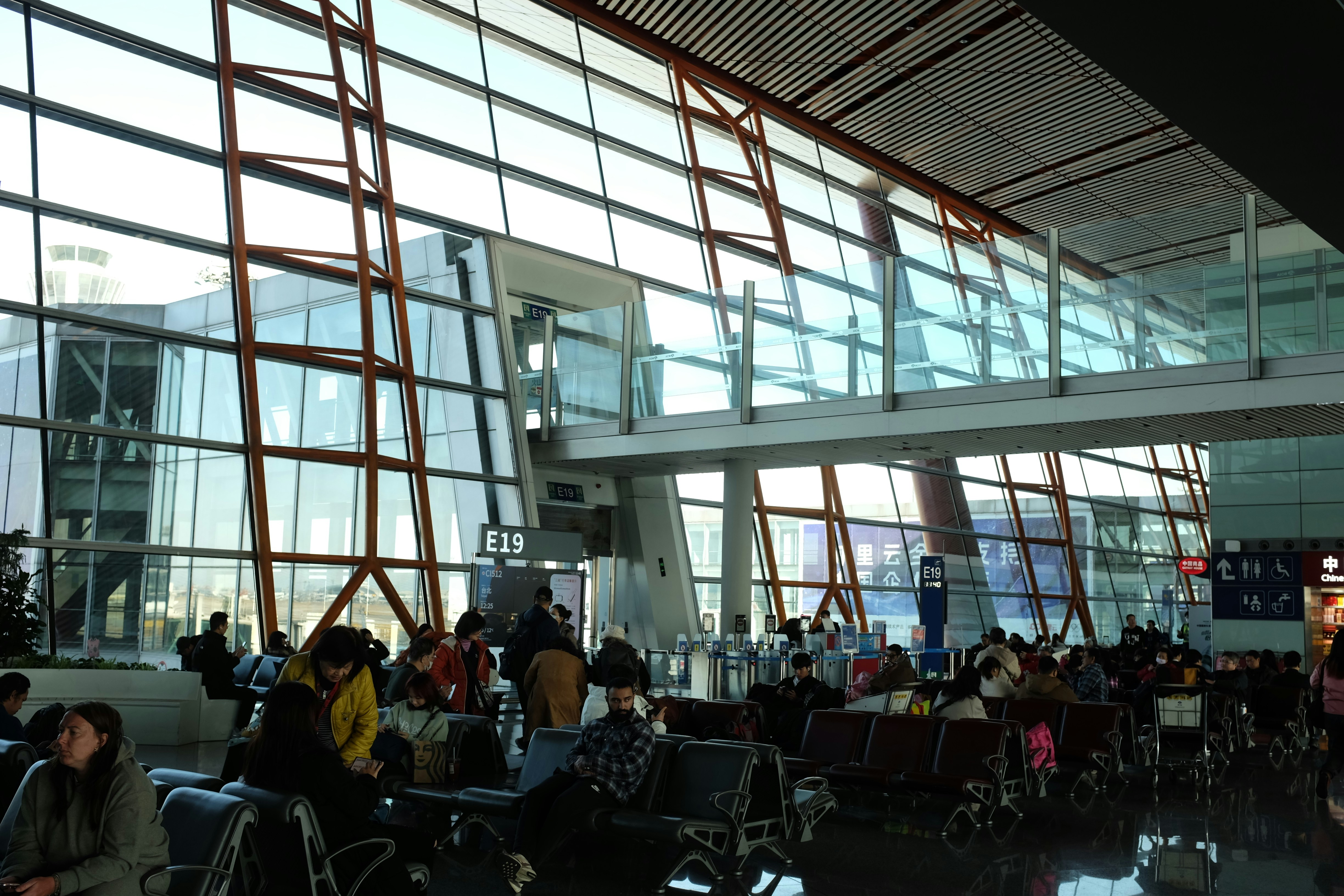 people-waiting-in-a-modern-airport-terminal-with-large-windows