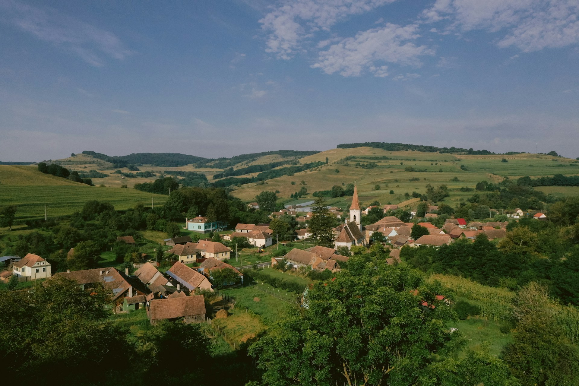 a-small-village-surrounded-by-lush-green-hills
