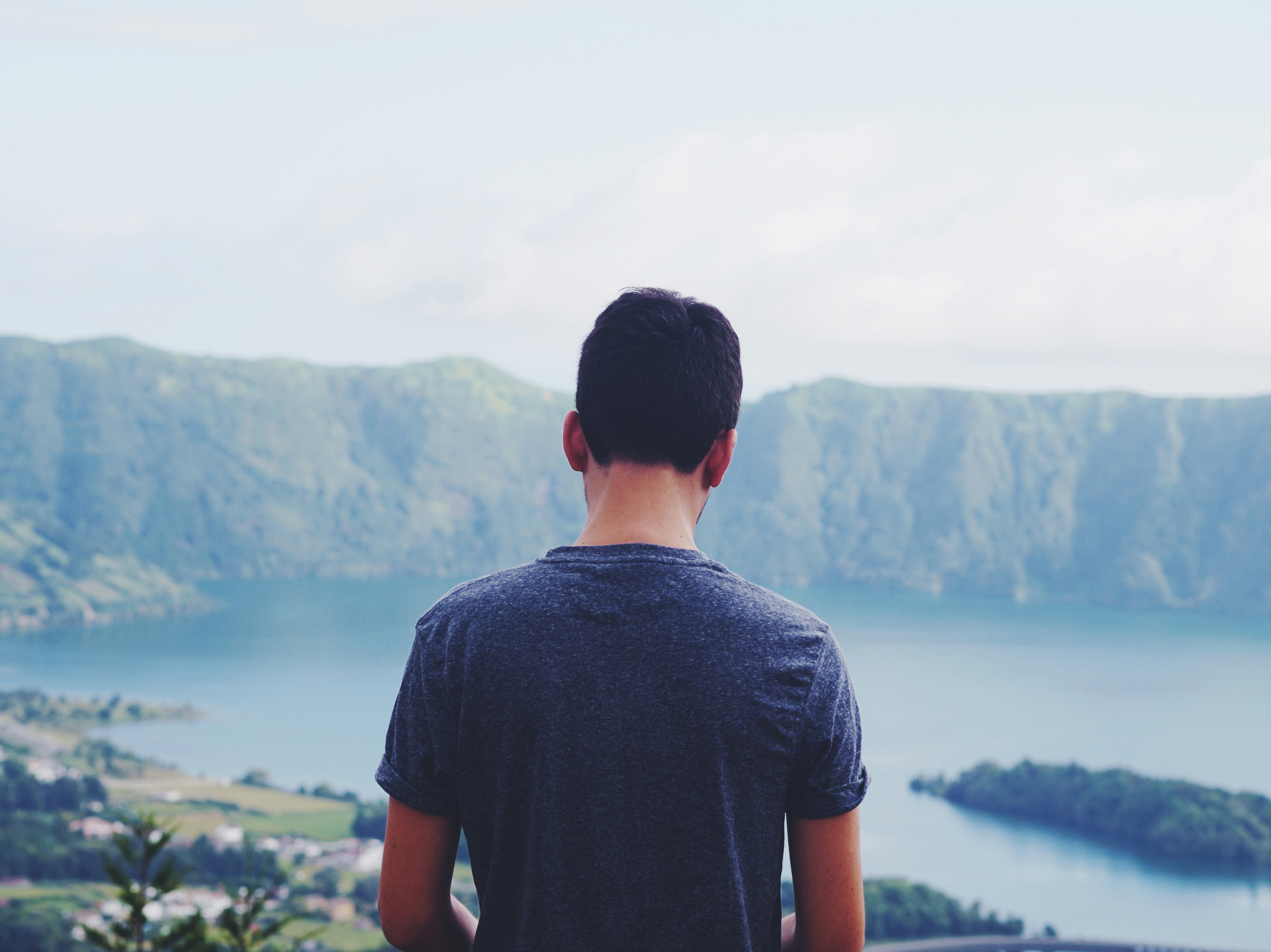 man-standing-outdoors-with-body-of-water-at-distance-during-daytime