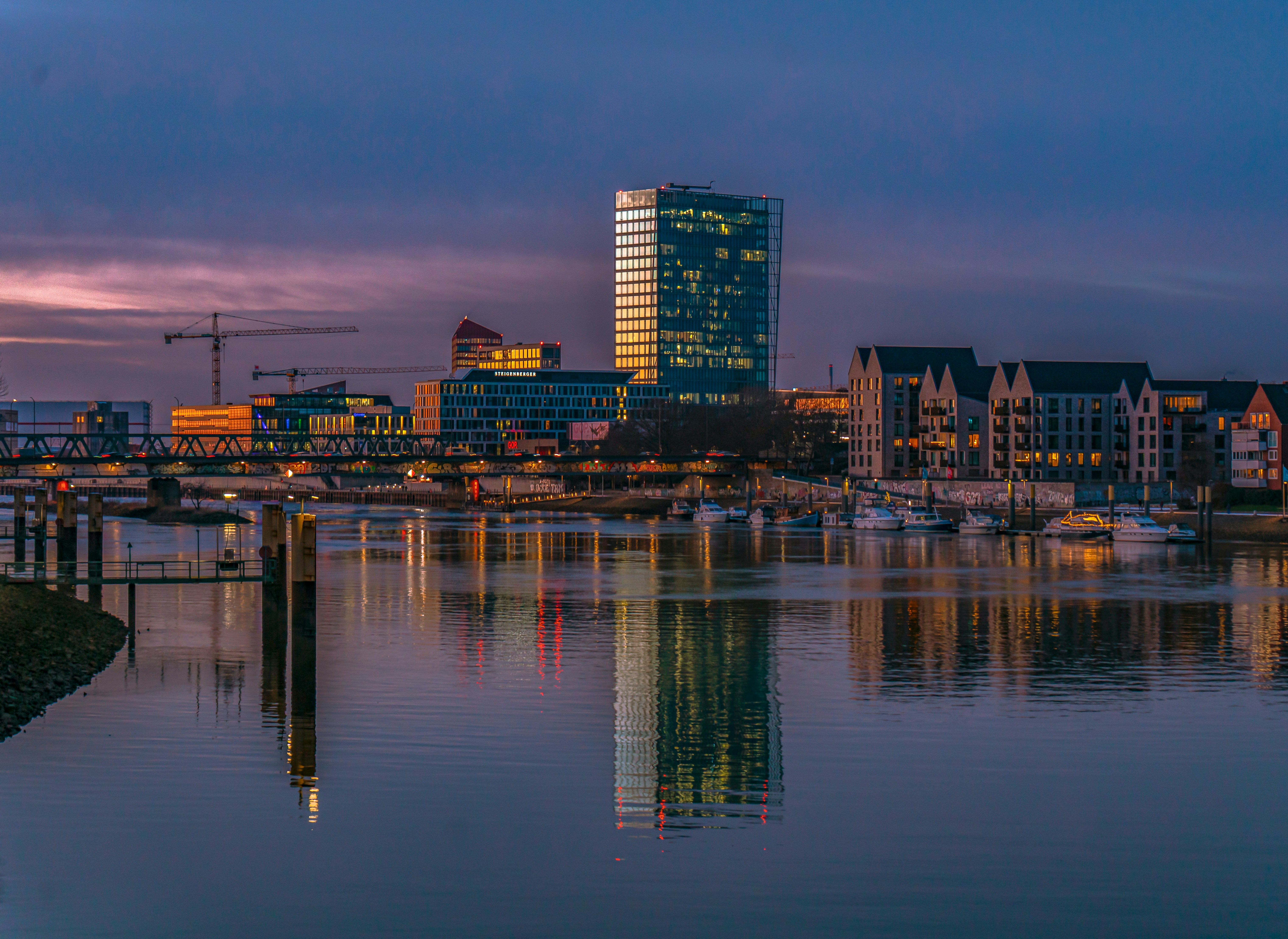 a-body-of-water-with-a-city-in-the-background