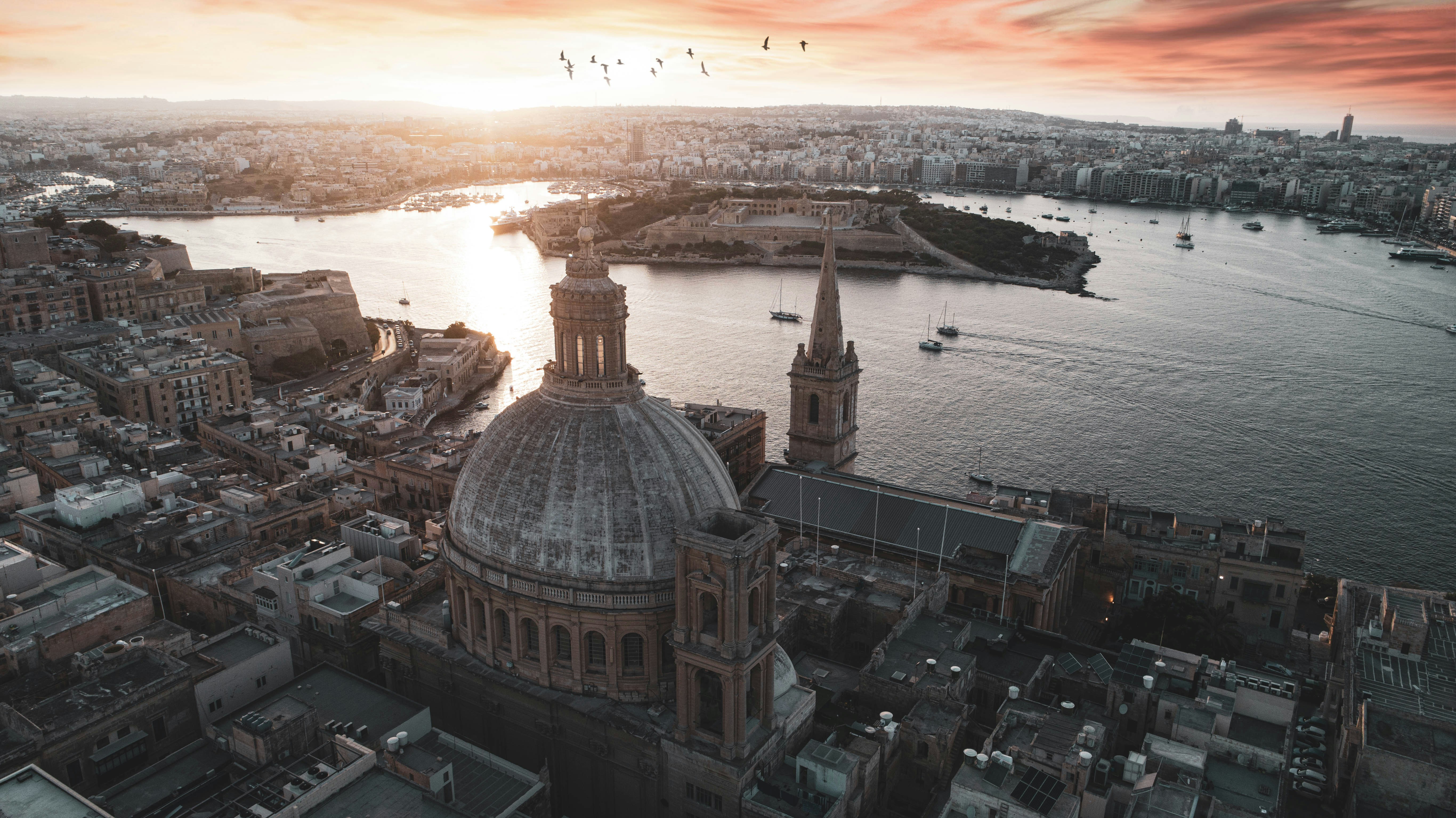 brown-and-white-dome-building-near-body-of-water-during-daytime