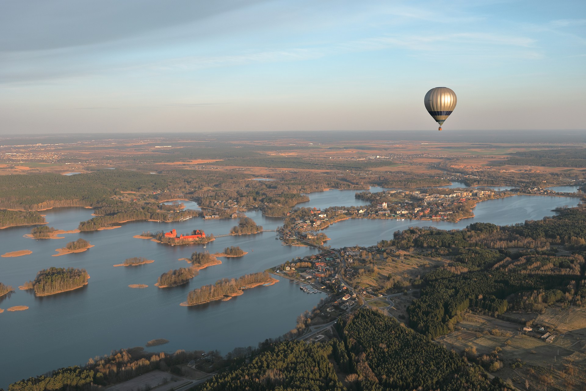 -hot-air-balloon-flying-over-a-large-body-of-water