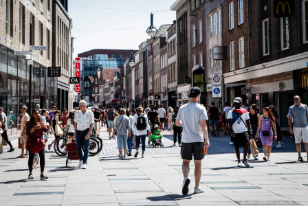 people walking between buildings