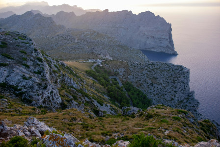 a-view-of-a-mountain-with-a-body-of-water-in-the-distance