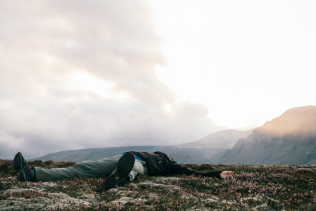 a-person-laying-on-the-ground-in-a-field