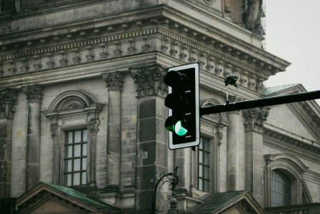 a-traffic-light-is-green-in-front-of-a-building