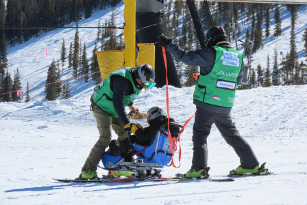 man-in-green-jacket-and-black-pants-standing-on-snow-covered-ground-during-daytime