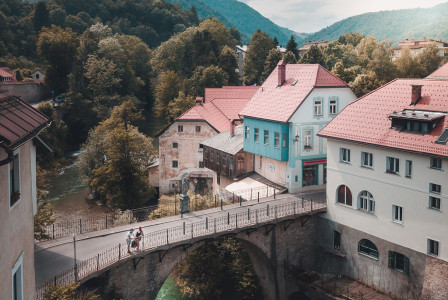 three-white-and-blue-concrete-house-near-brown-bridge