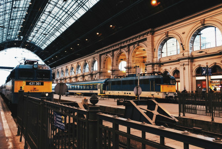 two-black-and-yellow-trains-on-train-station
