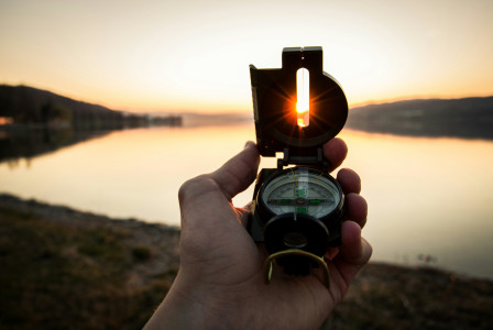 person-showing-black-and-white-compass