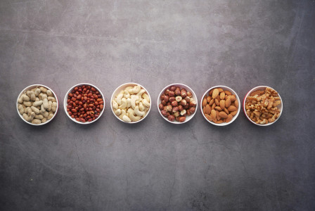 Assorted nuts in small bowls.