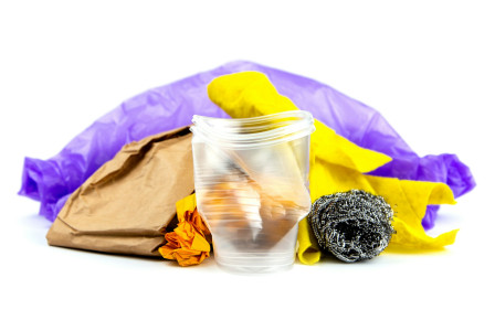 Colour photograph of assorted rubbish, food, plastic bags and sweets by Volodymyr Hryshchenko on unsplash.