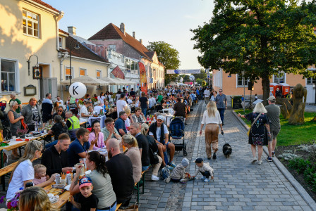 people-gathered-for-an-outdoor-festival-with-long-tables