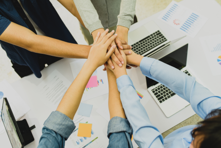 Image featuring a hand stack over a desk