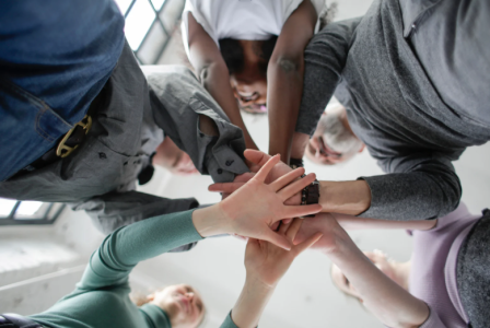 5 people doing a hand stack
