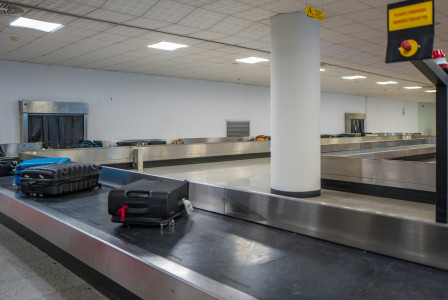 Luggage on a conveyor belt at an airport baggage claim