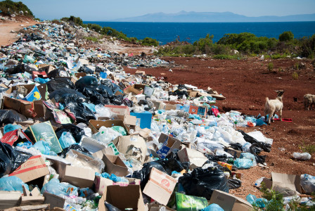 A picture presents a large pile of waste scattered near the coast.
