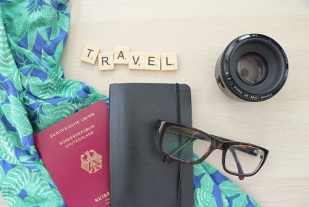 A picture presents travel essentials arranged on a table.