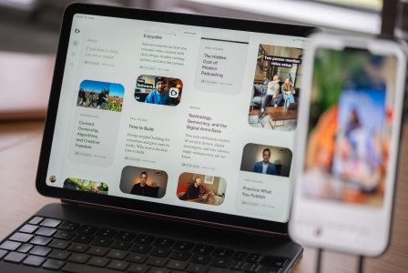 Digital content displayed on a tablet and blurred smartphone.