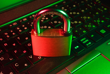 A photo presenting a padlock resting on a keyboard