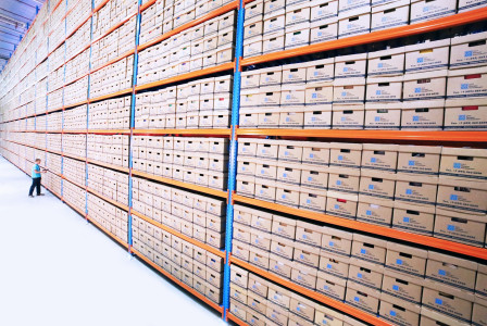 Colour photograph of brown and orange warehousing shelves.