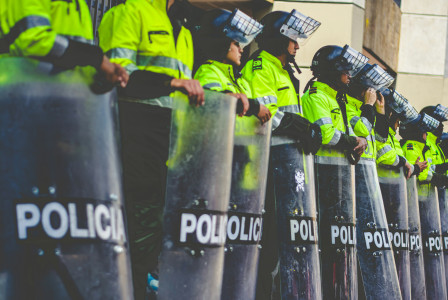 A row of police men standing next each other. 