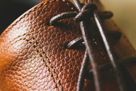 A close up of a brown leather shoe.